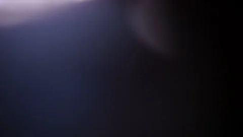 Light leak in 4K quality on dark background with.Real lens flare Stock Footage 86689933