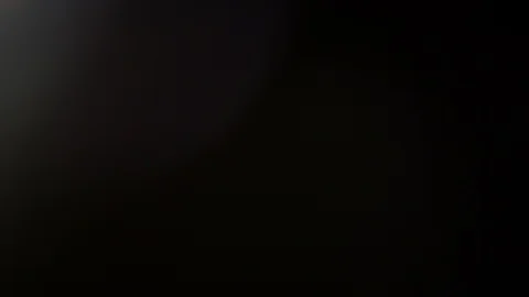 Light leak in 4K quality on dark background with.Real lens flare Video stock 86698462
