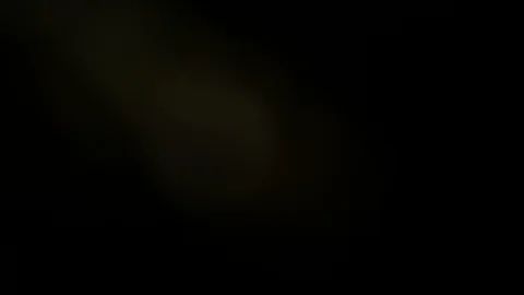 Light leak in 4K quality on dark background with.Real lens flare Stock Footage 86699212