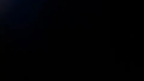 Light leak in 4K quality on dark background with.Real lens flare Stock Footage 86699307
