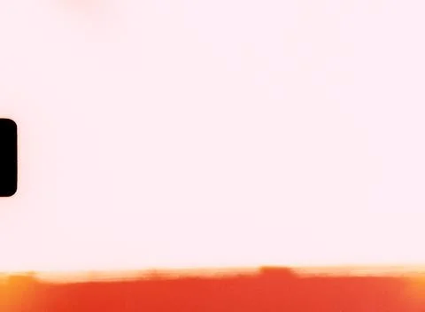 Light leak creating orange gradient on white background with black rectangle 库存照片