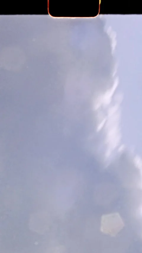 Light leak moving through lens creating abstract blue background, 8mm film Stock Footage 294683200
