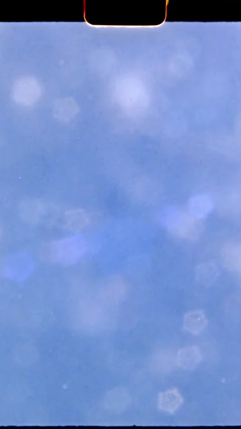 Light leak moving through lens creating abstract blue background, 8mm film Stock Footage 294683240