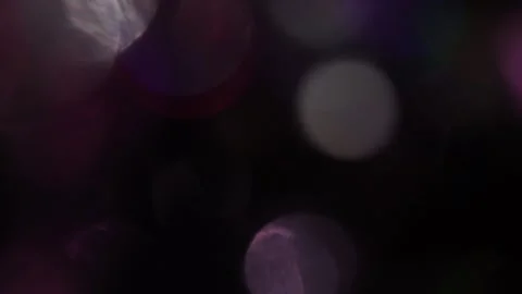 Light leaks in the form of dazzling colored bokeh in the dark Stock Footage 317447820