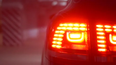 Light up the LED tail lights of a luxury car in the underground parking Stock Footage 91829112