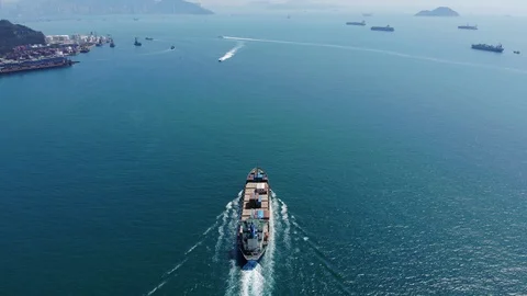 Light loaded container ship sail away to open waters, cinematic aerial shot Video stock 91699492