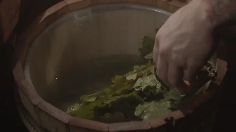 Light massage with oak leaf broom in russian sauna Stock Footage 61627784