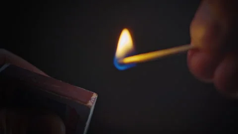Light a match on the box in the dark. Fire is beauty and danger. Shot close-up. Stock Footage 263366140