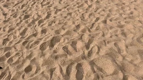 Light Mediterranean sand background with ridges and footsteps Stock Footage 107484057