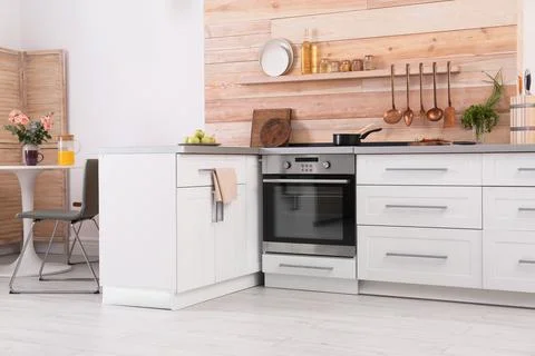 Light modern kitchen interior with new oven Stock Photos