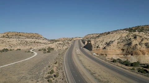 Light morning traffic on Interstate Freeway-70 through the desert Stock Footage 241463486