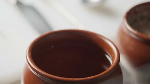 Light in motion. Play of light and shadow. Water in a clay jug. Light reflection 動画素材 139151060