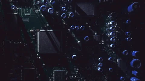 Light moves around the circuit board and create long moving shadows. Macro Stock Footage 61562429