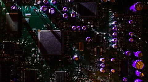 Light moves around the circuit board and create long moving shadows. Macro Stock Footage 61563085