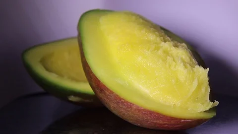 The light moves on the mango's half. Stock Footage 98661562
