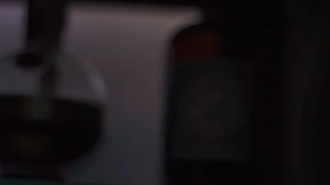 Light moving through hard liquor bottles in bar Stock Footage 90123428