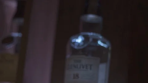 Light moving through liquor bottles in bar Stock Footage 90123445