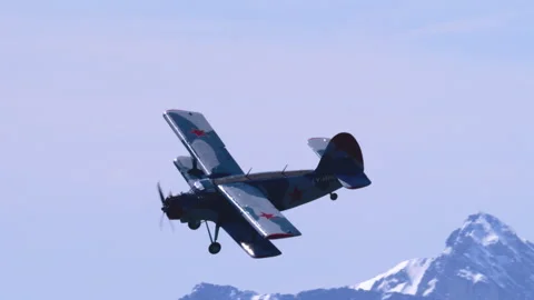 Light Multipurpose Airplane Antonov AN-2 Deep Banking Maneuver Over Alpine Peaks Stock Footage 332324824