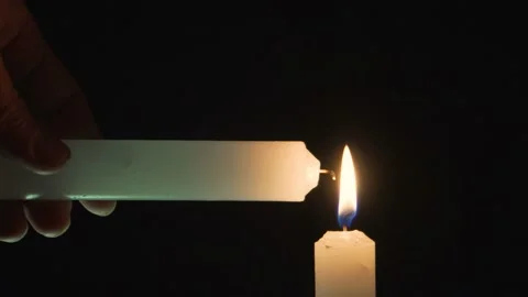 Light one candle from another 4K Stock Footage 101080011
