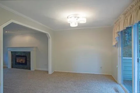 Light open dining area with arched doorway  leading to the living room. Has e Stock Photos