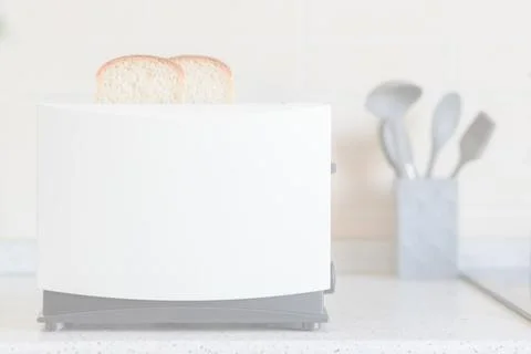 Light overexposed kitchen background with toaster and kitchen utensils on the Stock Photos