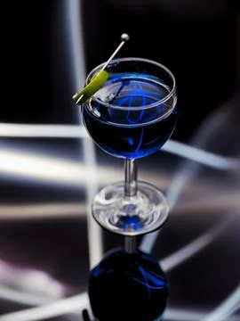 Light paining of blue liquid in a glass. Stock Photos