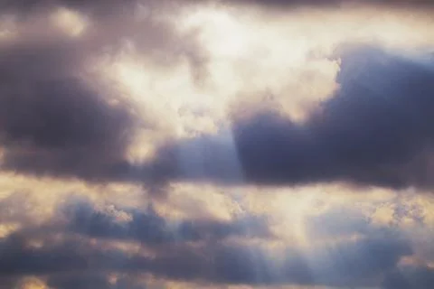 Light passes through the clouds, rays of light through the clouds. Stock Photos
