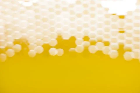 The light passes through the mesh structure, forming blurred hexagonal spots Stock Photos