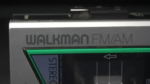 Light Passing Over a Sony Walkman Cassette Tape Player Dramatic Closeup Stock Footage 131105016