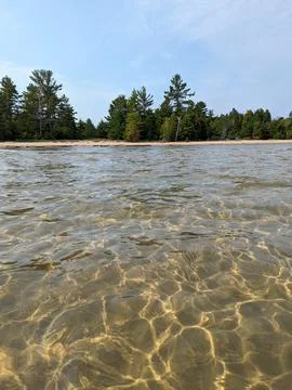 Light patterns in shallow water off the coast of sand coast beach Stock Photos