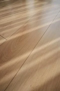 Light patterns on wooden floor surface during daytime hours Stock Photos