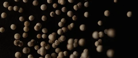 Light pepper peas falls out of focus on a dark surface Stock Footage 106008787