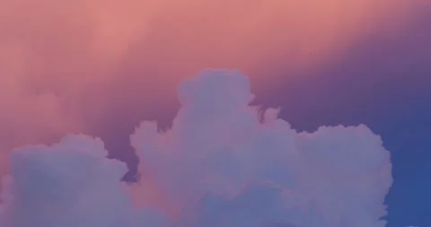 Light pink clouds in sunset blue sky. Pastel colors of clouds. Close-up. Stock Footage 252104621