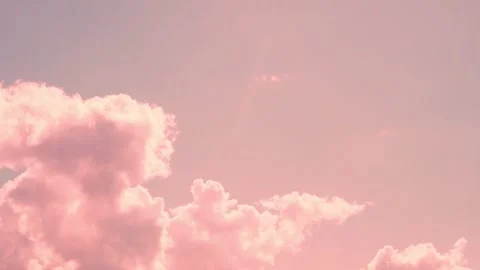 Light Pink Cumulus Cotton Clouds in Sunlight Sun Rays and Sunset Pink Blue Sky a Stock Footage 327782568