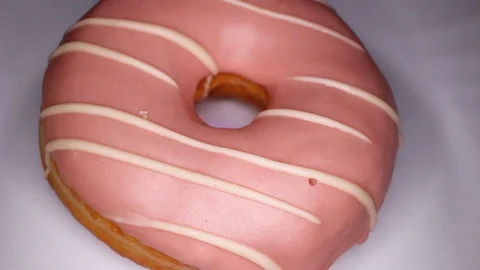 Light pink donut doughnut rotating seamless looping food texture pattern close Stock Footage 103079453