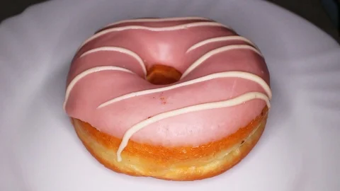 Light pink donut doughnut rotating seamless looping food texture pattern close Stock Footage 103090533