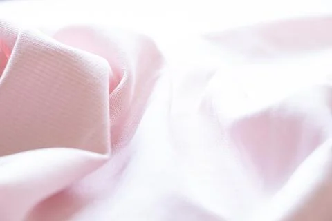 Light pink fabric texture close-up, wavy surface Stock Photos
