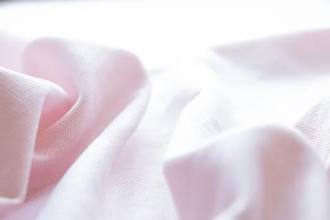 Light pink fabric texture close-up, wavy surface Stock Photos