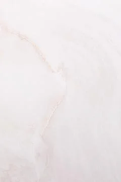 Light pink marble texture with soft swirls and subtle lines in natural patterns Stock Photos