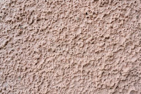 Light pink surface of the plastered wall, plaster made in the form of splashe Stock Photos