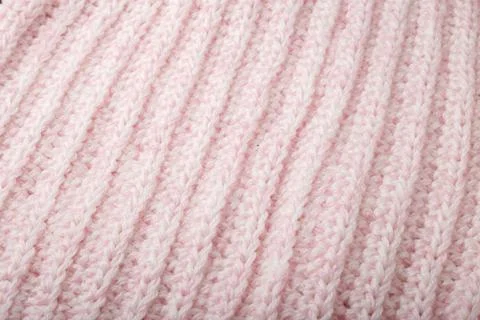Light pink woolen knitting braid pattern texture, knitted background Stock Photos