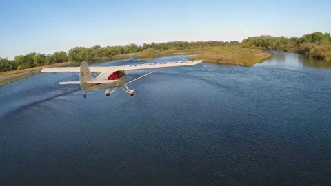 Light plane flying down river Stock Footage 240120262