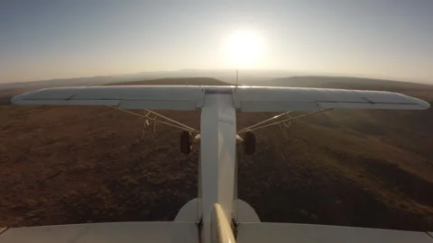 Light plane over hills dams and the savannah grasslands Stock Footage 310986292