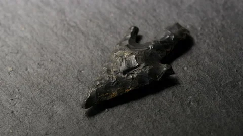 Light playing over neolithic flint arrowhead, close up 4k, UHD Stock Footage 48781512