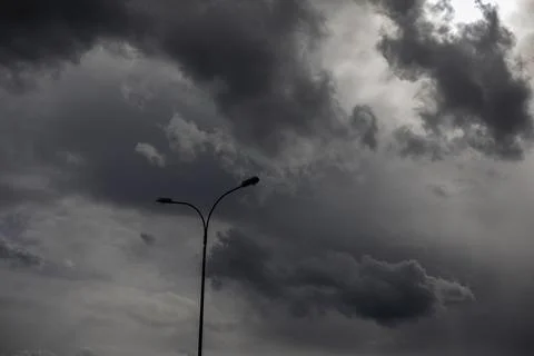 Light pole against sky. Celestial landscape in cloudy weather. Stock Photos