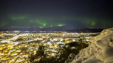 Light pollution and dancing aurora Stock Footage 250420924