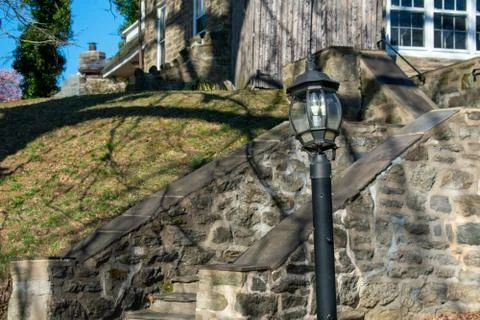 A Light Post in Front of Cobblestone Stairs Leading up to a Suburban Home Stock Photos