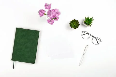 Light postcard mockup for design presentation on a white workplace with notebook Stock Photos
