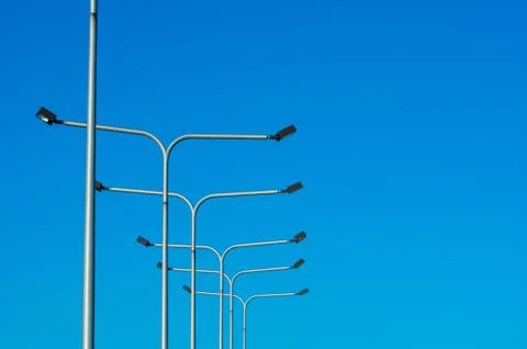 Light Posts Against Blue Sky Stock Photos