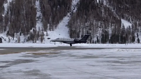 Light Private Jet landing at Mountain Valley executive airport in swiss alps Stock Footage 251659587